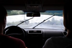 Couple in car, driving on a rainy day