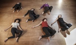 Six people lie on floor for Awareness Through Movement® lesson